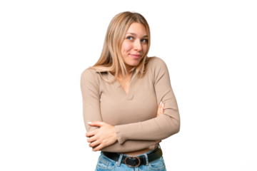 Young pretty blonde woman over isolated chroma key background making doubts gesture while lifting the shoulders
