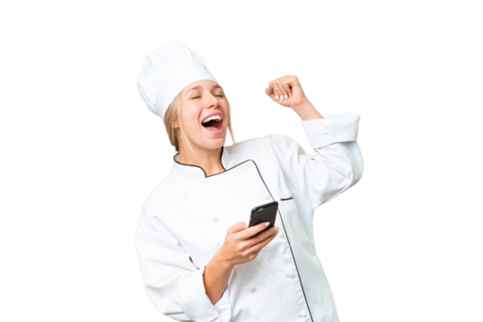 Young chef woman over isolated chroma key background with phone in victory position