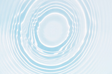 Blue water with ripples on the surface. Defocus blurred transparent blue colored clear calm water surface texture with splashes and bubbles. Water waves with shining pattern texture background.