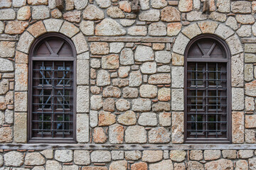 Symmetrical Arched Windows in a Stone Masonry Wall