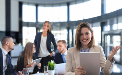 Happy smart business man with team mates discussing in the background