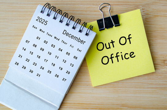 Out of office text on notepad with December calendar. Christmas Celebration. Holiday season concept. - Powered by Adobe