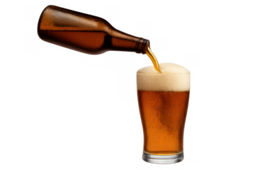 Amber beer pouring from a brown bottle into a pint glass, creating a frothy head. Transparent background