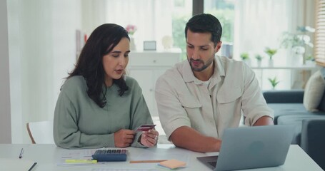Young Latin couple male, female customers paying by credit card online and laptop shopping online furniture decorate home in living room at home. Young married moving home shopper online concept. - Powered by Adobe