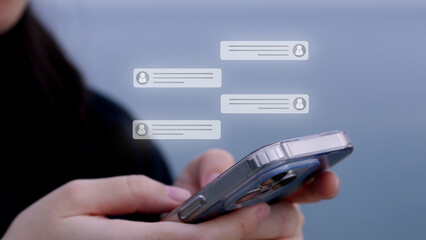 A person's hands hold a smartphone, with translucent speech bubbles layered above, suggesting a messaging or chat interface. The focus is on the interactive nature of mobile communication.	