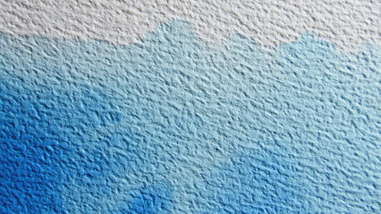 A textured paper canvas showcasing a beautiful watercolor gradient from pure white to a serene light blue, fading into a vibrant, deep blue hue.