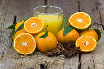 orange juice and some fresh fruits on wooden background