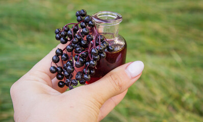 Elderberry berries, syrup, and herbal supplement capsules for natural cold and flu remedy.