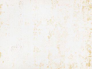 Rusty white textured background with orange speckles creating abstract grunge pattern