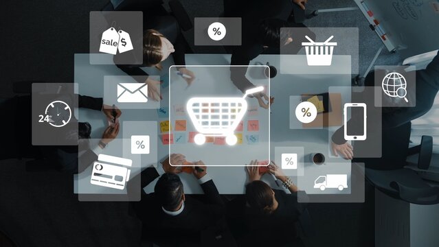 A diverse business team collaborates around a table, utilizing digital icons to enhance their e-commerce strategy, showcasing modern marketing techniques and innovation. Raster - Powered by Adobe