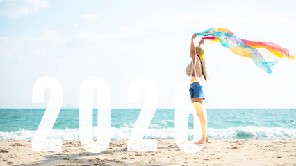 Asian young woman happy  jumping congratulation and celebrate in Happy New year 2026 for change new life future concept. Freedom lifestyle jump as part of Number 2026 success on the sand beach outdoor