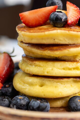 Stack of Pancakes on Plate with Berries Close-up.