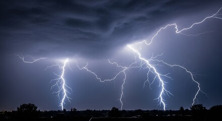 Electrifying thunderstorm over a cityscape at night illuminating the sky