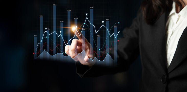 Businesswoman interacts with a digital display showcasing various graphs and charts, emphasizing data analysis and technology in a professional office environment. Scalp