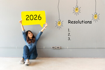 Fototapeta premium 2026 resolutions with young woman pointing resolutions cheerful and happy new year with laptop on the sofa in living room. Star together new year 2026