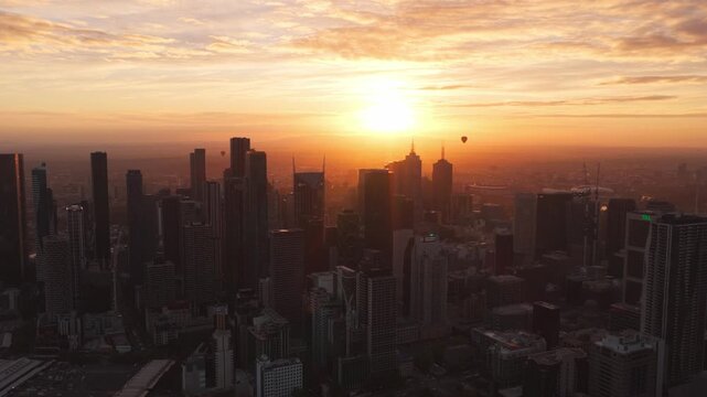 Hot Air Balloons Rising Over Melbourne City Skyline at Sunrise