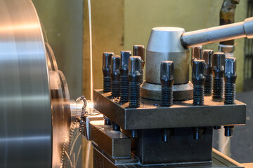 Close up scene the lathe machine finish cut metal shaft parts with liquid coolant method.