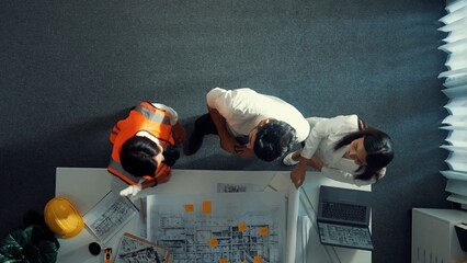 Top view of smart architect and skilled civil engineer team working together to design building...