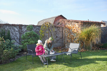 Outdoor winter relaxation with family in cozy garden setting