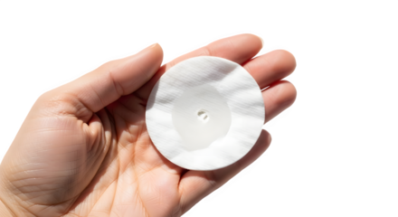 Woman's hand holding a round wet cotton pad used for facial skincare and hygiene. isolated PNG with Transparent Background