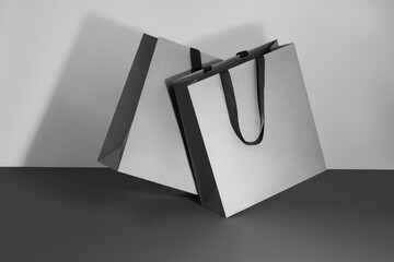 Grey paper glossy shopping bag mockup with a fabric handle