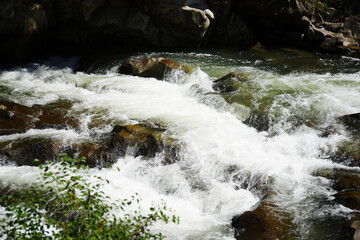 Small mountain waterfall, rapids of a mountain river