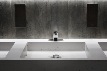 White marble washbasin on a gray wall background