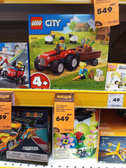 Fototapeta premium Zvyagel, Ukraine - November 20, 2025: LEGO City tractor set displayed on store shelf, featuring farmer minifigure and accessories, ideal for creative play and imaginative storytelling