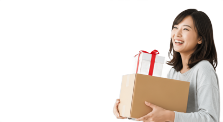 Smiling young Asian woman with shoulder-length dark hair holding a stack of packages, including a brown box and a white gift box with red ribbon, wearing a light grey top, isolated on a pure white bac