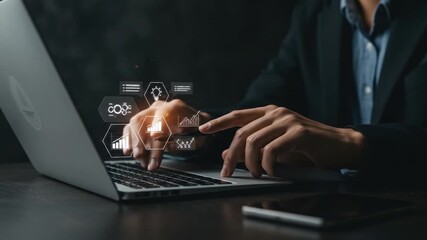 A person in a suit works on a laptop with digital data overlays. The image is on a dark background with orange light flares - Powered by Adobe