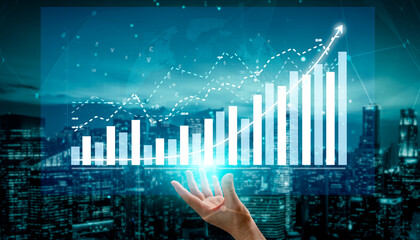A hand reaches towards a digital display of growth charts and graphs, representing the future of business analytics and data-driven decisions in a modern cityscape. Impute