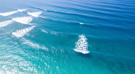Majestic sailboat glides gracefully across sunlit azure ocean waves under clear skies