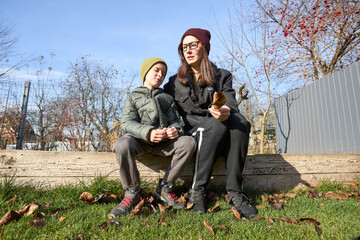 Mother and child enjoying autumn on a sunny day outdoors