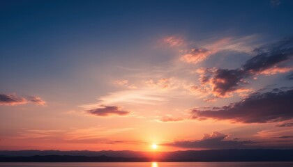 Fototapeta premium Vibrant Sunset over Calm Lake with Silhouetted Mountains and Colorful Clouds