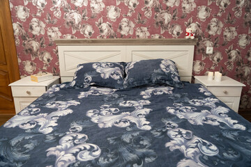 Floral bedroom scene with patterned bedding and soft lighting, creating a warm and inviting resting space.