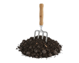 Small metal cultivator tool resting upright in a mound of rich, dark earth