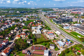 Aerial panorama of Krakow, Poland, showing the Podgórze district. View of the major Nowohucka road intersecting dense urban allotment gardens and residential areas.