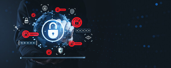Cybersecurity threat detection concept with glowing padlock icons, warning signs, and data symbols on dark digital background held by hand on tablet.