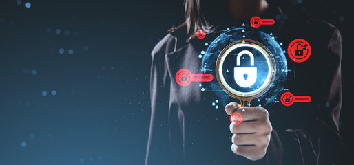 Cybersecurity warning concept showing person holding magnifying glass over digital padlock with red alert icons on futuristic background.