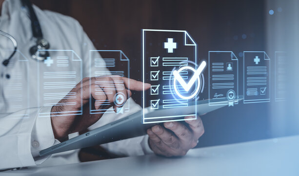 Doctor using digital tablet with glowing medical checklist icons in futuristic interface concept on dark background, representing healthcare data management.