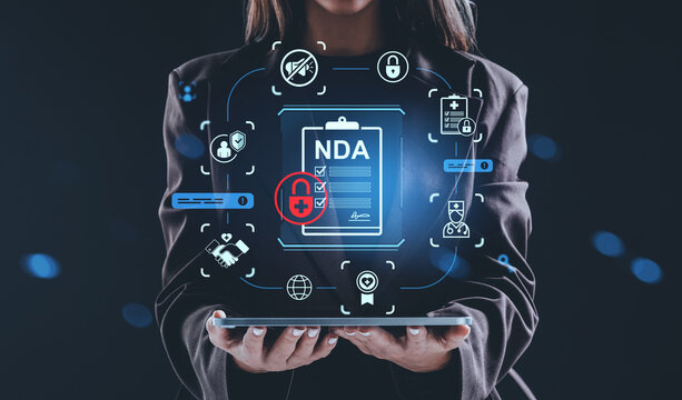 Businesswoman holding tablet with NDA confidentiality agreement - Powered by Adobe