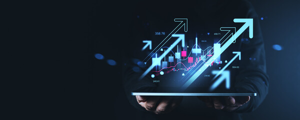 Digital financial growth concept with glowing chart and arrows emerging from tablet in creative business-themed composition on dark background.