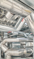 Heating and cooling pipe system with exhaust silencer in a heating plant.