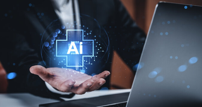 Businessman holding AI tech hologram near laptop, futuristic digital healthcare interface concept with glowing elements on modern background..
