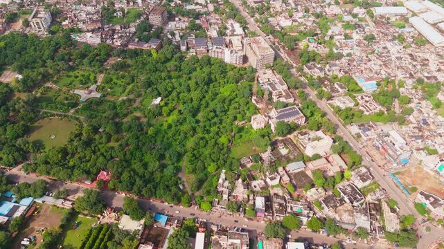 Aerial panorama of Alwar revealing green patches, residential clusters, and a long stretch of the Aravalli hills forming a natural horizon behind the city.