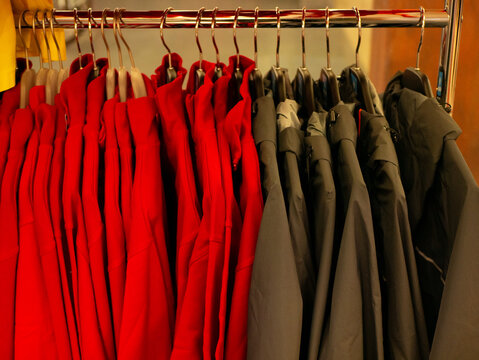 Clothing hanging on a store rack, arranged in an organized retail display suitable for fashion catalogs, apparel merchandising, showroom presentations, and commercial promotions. High quality photo