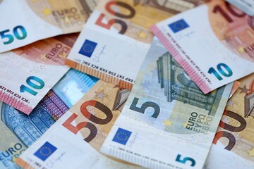 Euro money bills banknotes in big amount on table close up. Huge quantity of European Union currency cash on smooth surface. Business and rich life concept