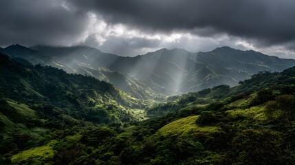 Dramatic Sunbeams Breaking Through Storm Clouds Over a Lush Green Mountain Valley.