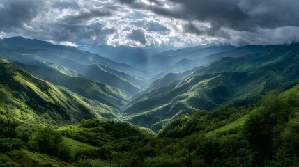 Dramatic Sunbeams Pierce Storm Clouds Over Lush Green Mountain Valley.