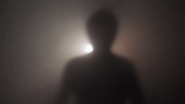 Blurry shadow figure slowly moving behind frosted glass with fog and red glow, eerie horror tension